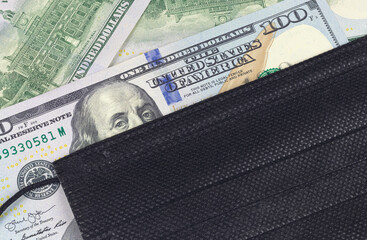 A face shield on a hundred dollar bill