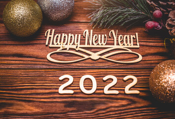 Happy new year 2022 on wooden brown background
