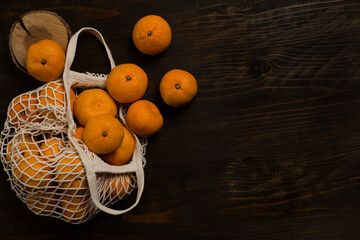 Fresh mandarin oranges fruit or tangerines on a wooden table. Christmas composition with tangerines, fir branches, cinnamon sticks. Flat lay, top view - 477521743