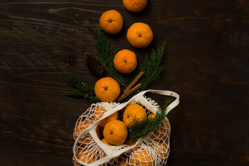Fresh mandarin oranges fruit or tangerines on a wooden table. Christmas composition with tangerines, fir branches, cinnamon sticks. Flat lay, top view - 477521753