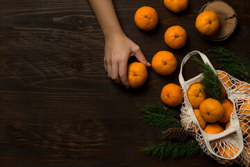 Fresh mandarin oranges fruit or tangerines on a wooden table. Christmas composition with tangerines, fir branches, cinnamon sticks. Flat lay, top view - 477521760
