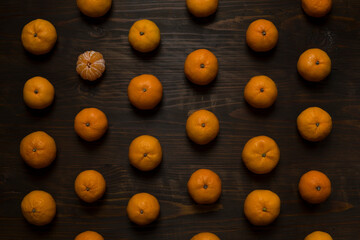 Fruit pattern mandarins on wooden background, top view. Fresh mandarin oranges fruit or tangerines...