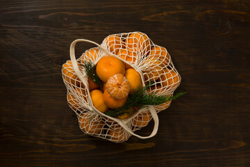 Fresh mandarin oranges fruit or tangerines on a wooden table. Christmas composition with tangerines, fir branches, cinnamon sticks. Flat lay, top view - 477521791