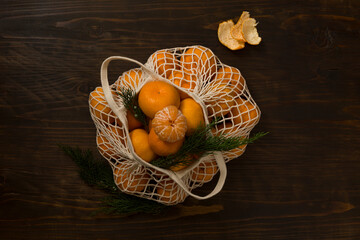 Fresh mandarin oranges fruit or tangerines on a wooden table. Christmas composition with tangerines, fir branches, cinnamon sticks. Flat lay, top view - 477521799