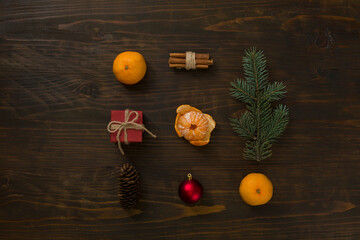 Composition with Christmas ball, gift, cinnamon and tangerines on wooden background, flat lay. Holiday Decoration. Fresh mandarin oranges fruit or tangerines on a wooden table - 477521903