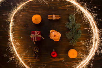 Composition with Christmas ball, gift, cinnamon and tangerines on wooden background, flat lay. Holiday Decoration. Fresh mandarin oranges fruit or tangerines on a wooden table - 477521907