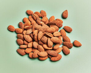  Bunch of delicious almonds over green background
