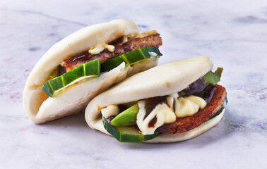  Two bao bun on a marble surface