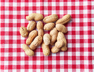  Bunch of peanuts with shell on a textile surface