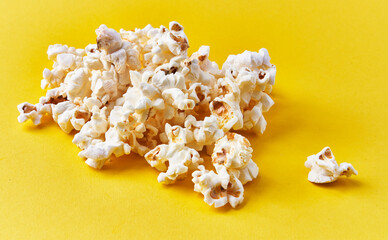  Bunch of salty popcorns on a yellow background