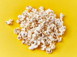  Bunch of salty popcorns on a yellow background