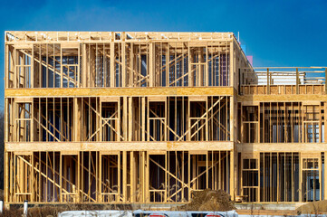 New residential construction home framing against sky