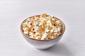  Bowl of salty popcorns isolated on a white background
