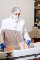 Meat processing plant.People working at a chicken factory - stock photo.Automated production line in modern food factory.