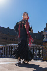Beauty flamenco dancer performing on a bridge outdoors