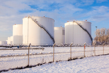 white tanks in tank farm with snow in winter