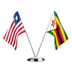 Two table flags isolated on white background 3d illustration, liberia and zimbabwe