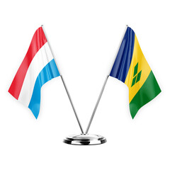 Two table flags isolated on white background 3d illustration, luxembourg and saint vincent and the...