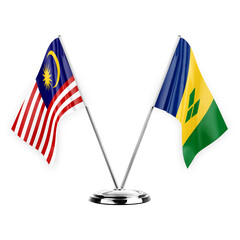 Two table flags isolated on white background 3d illustration, malaysia and saint vincent and the...