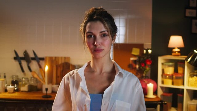 Woman sad housewife portrait. Young unhappy wife standing in cozy kitchen close-up. Cooking family romantic dinner.
