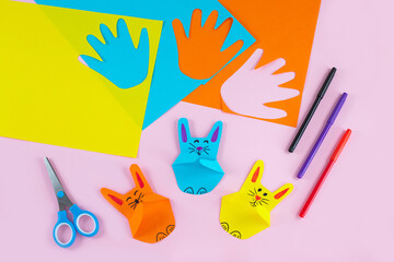 Colorful paper bunnies from childrens palm of their hand.