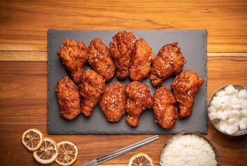 Korean fried chicken with spicy sauce  traditional Korean food, Fried chicken with rice and Kimchi pickle on wooden table.