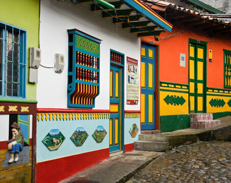 Guatape, Colombia: Calle del Recuerdos is a cobblestone pedestrian street that passes between colorful tile-roofed buildings decorated with zocalos (friezes) and hanging pots of flowers