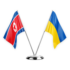 Two table flags isolated on white background 3d illustration, north korea and ukraine