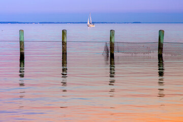 maryland coast boat with breakwater and posts at sunset blue hour