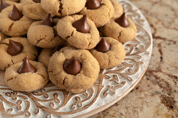 homemade peanut butter kiss cookies on carved wooden plate