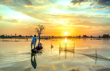 The ferryman rowed a boat to take guests through the wetlands to return home at sunset, the idyllic...