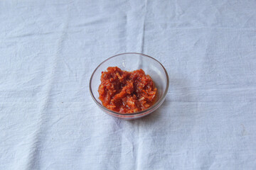 Lunu miris cup on the white background, hot chili pepper sauce paste