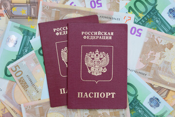 Two  Russian passports are on the background of euro banknotes. passports are intended for travel outside of Russia. Europe travel concept - 477547731