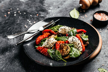 Grilled vegetables salad red bell pepper, zucchini, eggplant with spinach leaves and feta cheese. Detox and healthy superfoods bowl concept