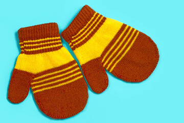 Baby mittens on a blue background.