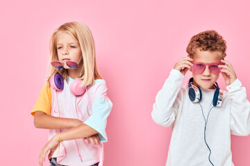 adorable little kids in sunglasses have fun with friends Listening music