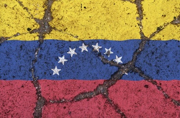 Venezuela flag on cracked asphalt. The concept of crisis, default, pandemic, conflict, terrorism. Out of focus image
