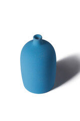 Detailed shot of a blue vase. The vase is tall and large with a narrow neck. The surface of the vase is textured. The blue decor item is isolated on the white background.