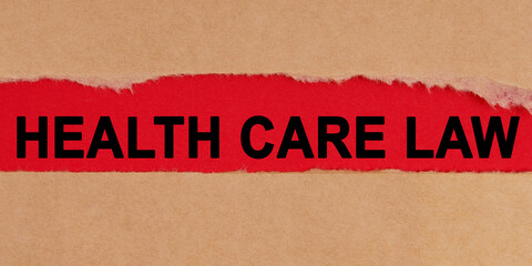 Among the torn sheets of paper on a red background, the inscription - HEALTH CARE LAW