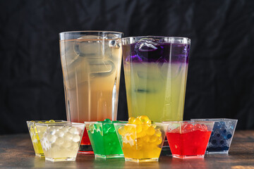 Lemonade with bubble tea on dark wooden background