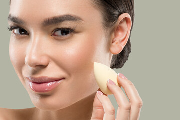 Woman clean skin with sponge beauty healthy skin beauty. Color background. Green