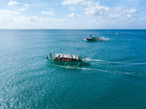 Laiya, Batangas, Philippines - An outrigger boat carrying tourists on an island hopping tour.