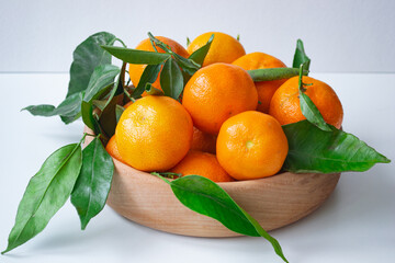 tangerines in a wooden plate