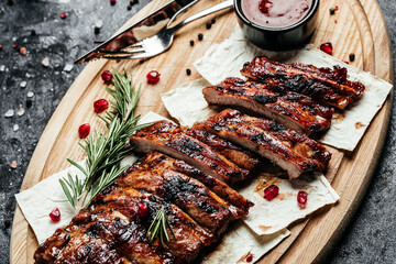 Spicy rack of spare ribs with BBQ sauce served on wood chopping board, Restaurant menu, dieting,...
