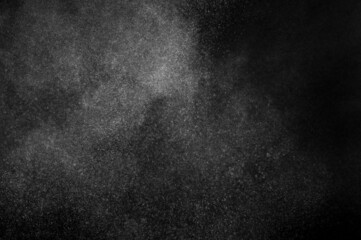 White powder explosion on black background. Abstract white dust texture.