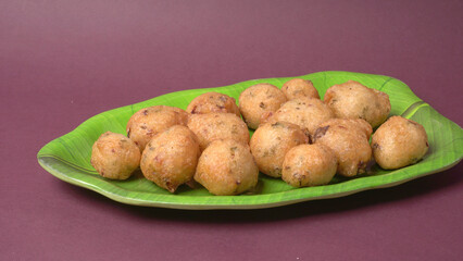 Delicious Indian snacks Punugulu served in a plate with Tomato and green Chutney