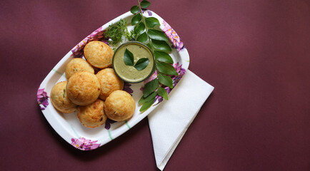Appum or Appe, Appam or Mixed dal or Rava Appe served with green   chutney. A Ball shape popular south Indian breakfast dish, Selective focus

