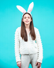 Surprised girl with bunny ears on Easter day on isolated background.