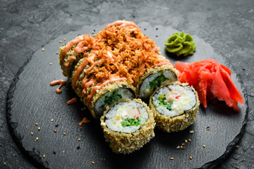 Grilled sushi rolls with salmon and eel on black background. Sushi menu. Japanese food.