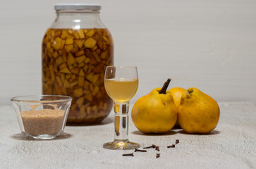 Homemade quince liqueur. Maceration of quinces in water, cane sugar, cinnamon, cloves and alcohol.
